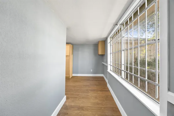 a view of hallway with wooden floor