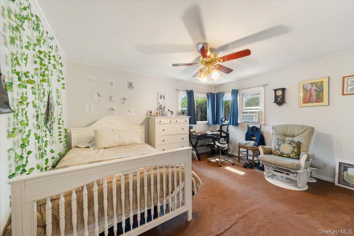 101 Cresthill Road Yonkers, NY 10710 - Photo 15 of 31 a bedroom with furniture and a large window