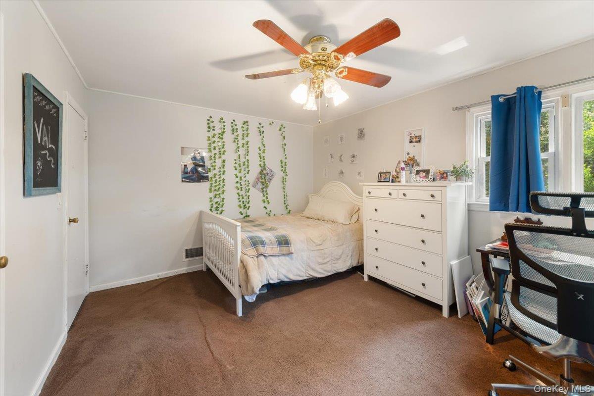 101 Cresthill Road Yonkers, NY 10710 - Photo 16 of 31 a bedroom with a bed and a chandelier