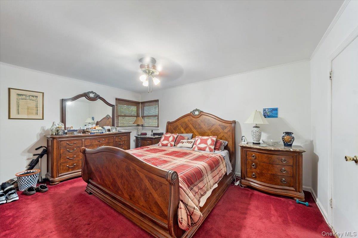 101 Cresthill Road Yonkers, NY 10710 - Photo 18 of 31 a bedroom with a bed a dresser and chair