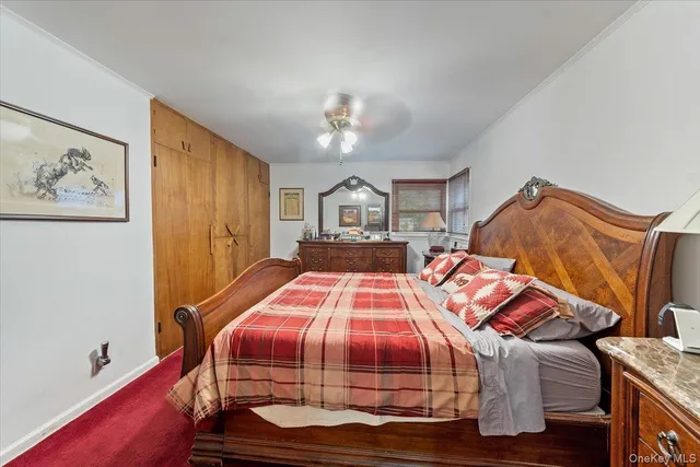 a bedroom with bed and wooden floor