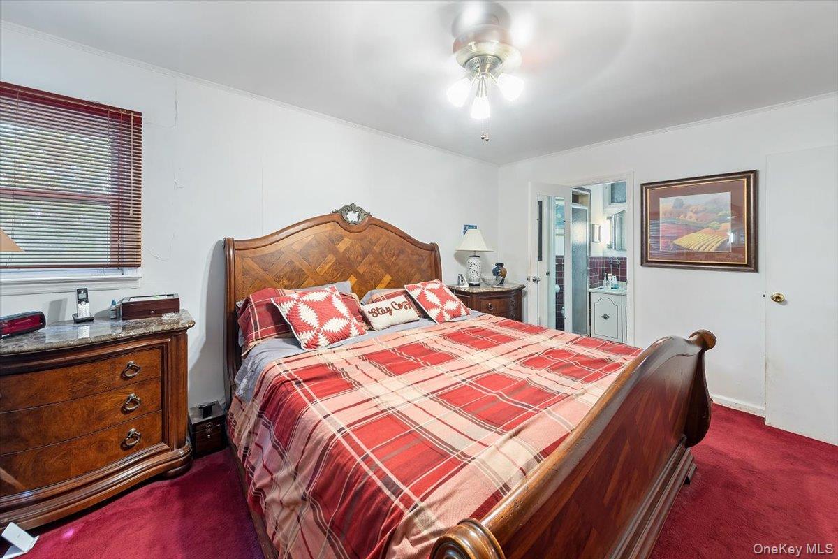 101 Cresthill Road Yonkers, NY 10710 - Photo 20 of 31 a bedroom with a bed and wooden floor