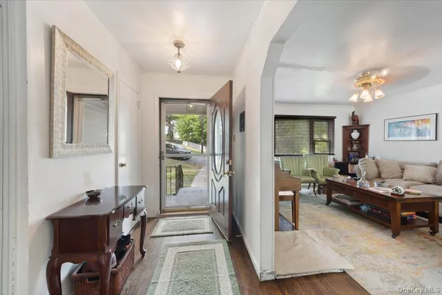 a living room with furniture and a chandelier