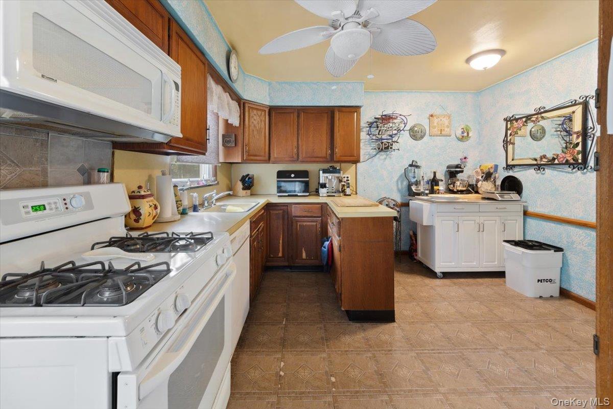 101 Cresthill Road Yonkers, NY 10710 - Photo 10 of 31 a kitchen with a sink appliances and cabinets