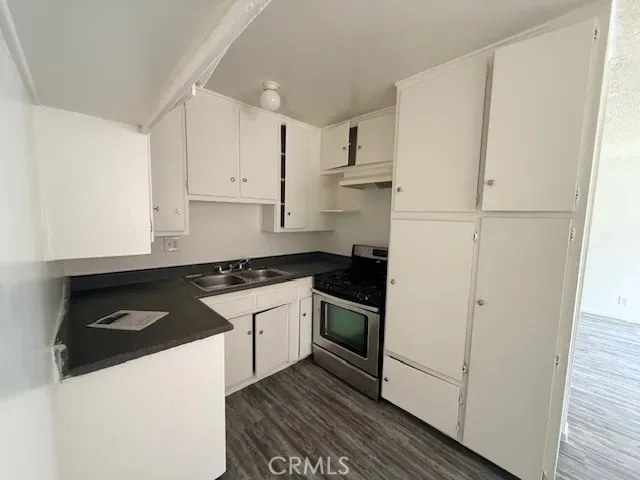 a kitchen with white cabinets and white appliances
