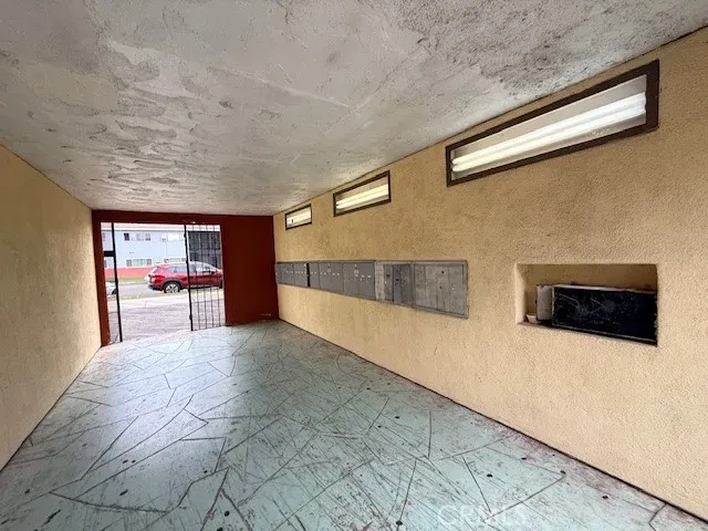a view of a hallway with furniture