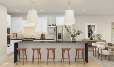 a kitchen with white cabinets and chairs