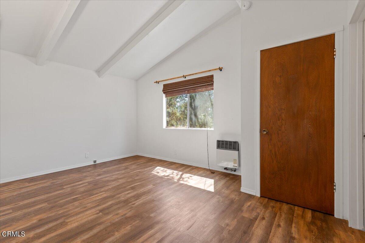 40069 Matthew Road Caliente, CA 93518 - Photo 22 of 31 an empty room with wooden floor and windows