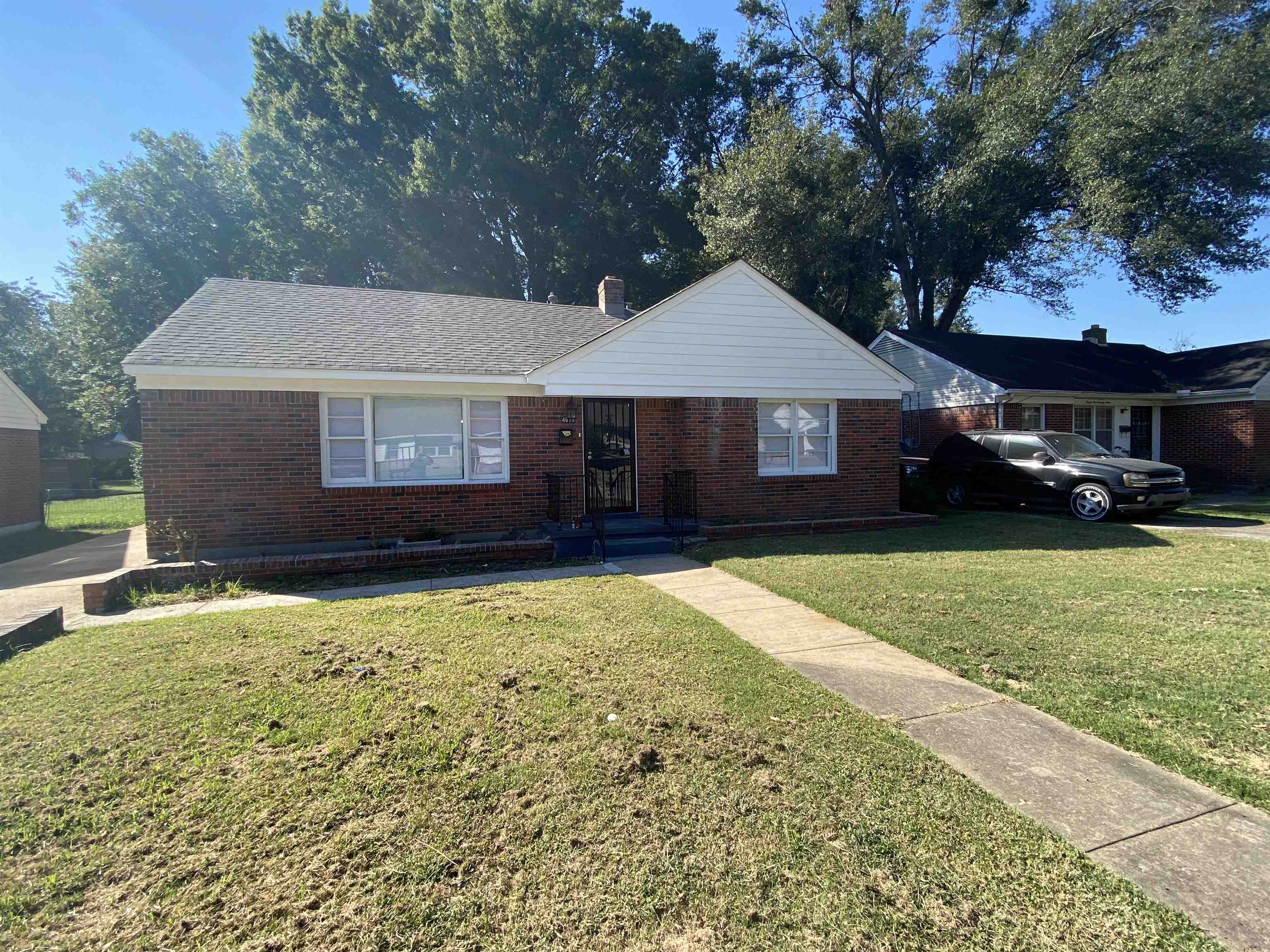 4679 Lynn Road Memphis, TN 38122 - Photo 1 of 8 a front view of a house with a garden and yard