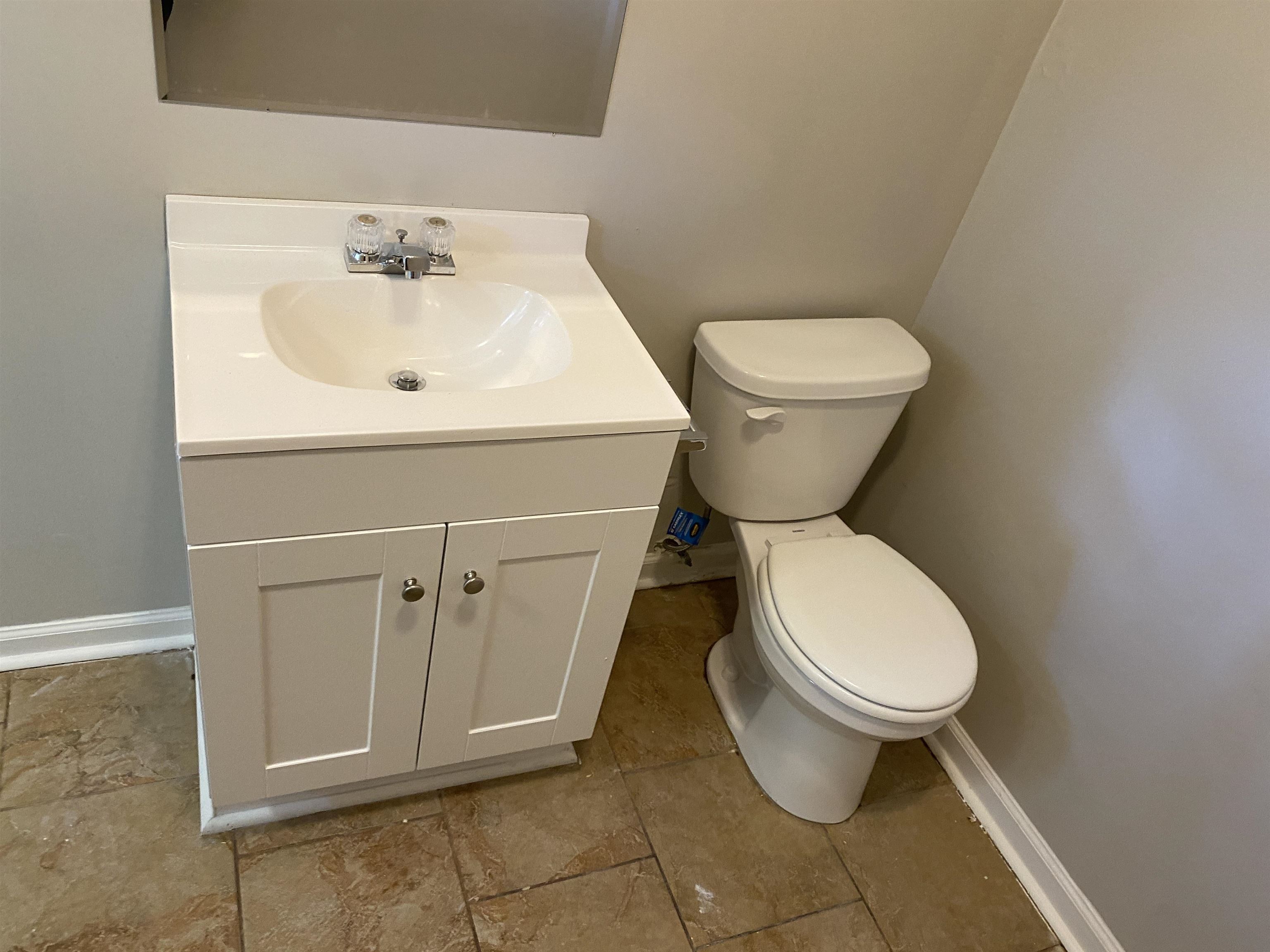 4679 Lynn Road Memphis, TN 38122 - Photo 6 of 8 a bathroom with a toilet sink and mirror