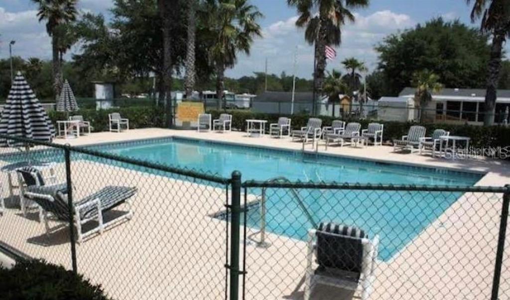 20285 Highway 27, Unit 8 Clermont, FL 34715 - Photo 14 of 16 a view of swimming pool with outdoor seating and plants