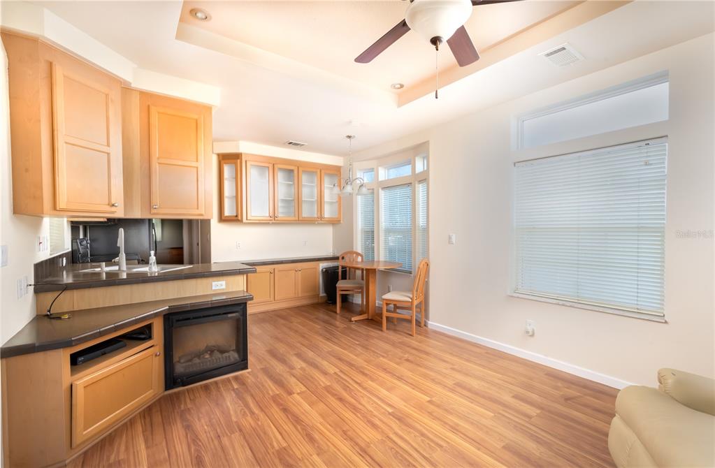 20285 Highway 27, Unit 8 Clermont, FL 34715 - Photo 2 of 16 a kitchen with stainless steel appliances granite countertop a stove a sink and a refrigerator with wooden floors