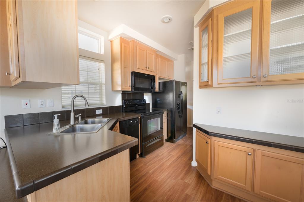 20285 Highway 27, Unit 8 Clermont, FL 34715 - Photo 5 of 16 a kitchen with granite countertop a sink a counter top space appliances and cabinets