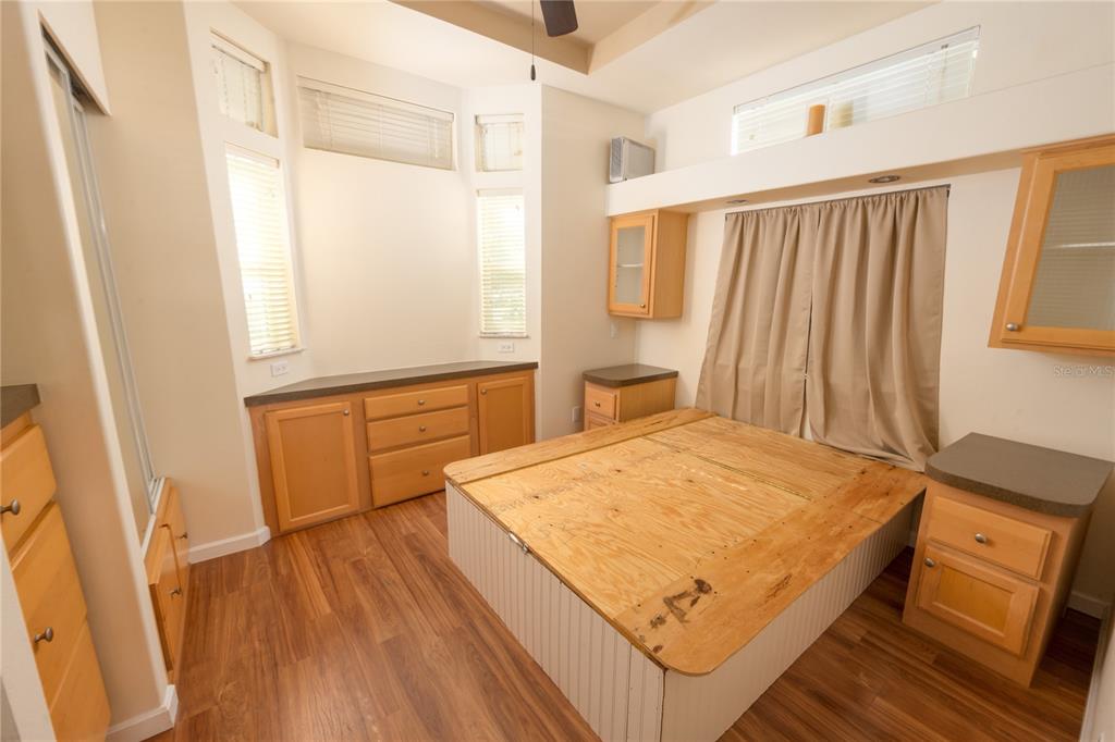 20285 Highway 27, Unit 8 Clermont, FL 34715 - Photo 6 of 16 a bedroom with a bed and wooden floor