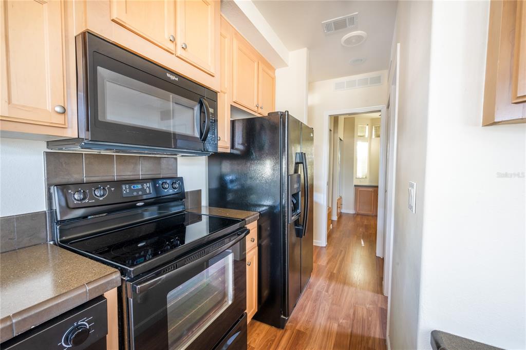 20285 Highway 27, Unit 8 Clermont, FL 34715 - Photo 9 of 16 a kitchen with a stove and a microwave