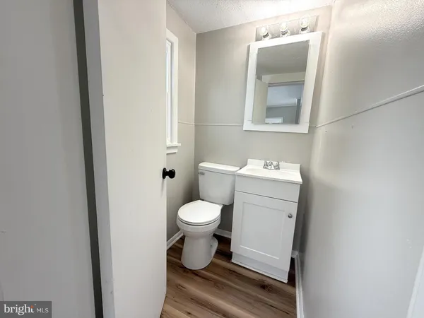 a white toilet sitting next to a bathroom sink