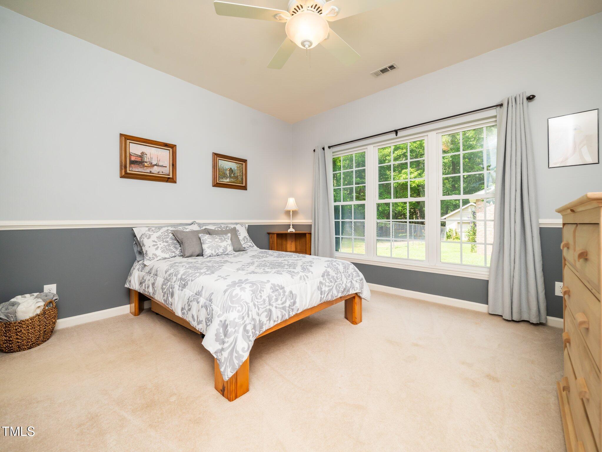 8917 Thompson Mill Road Wake Forest, NC 27587 - Photo 15 of 42 a bedroom with a bed and a large window