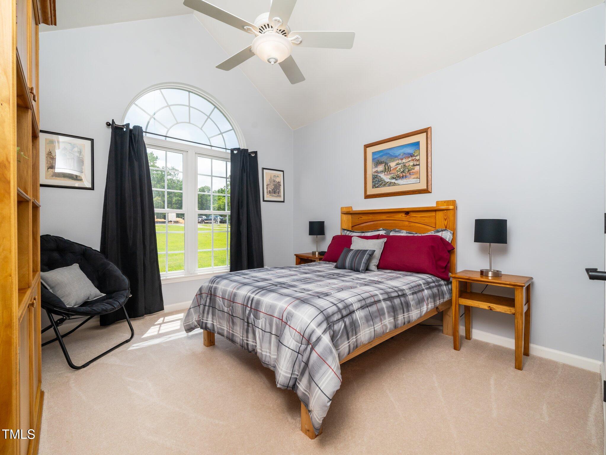 8917 Thompson Mill Road Wake Forest, NC 27587 - Photo 19 of 42 a bedroom with a bed dresser and a window
