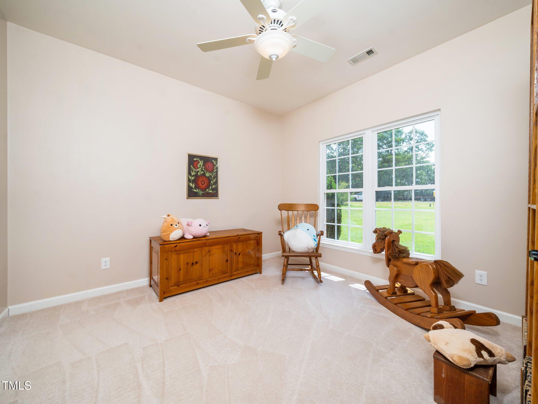 8917 Thompson Mill Road Wake Forest, NC 27587 - Photo 20 of 42 a living room with furniture and a window