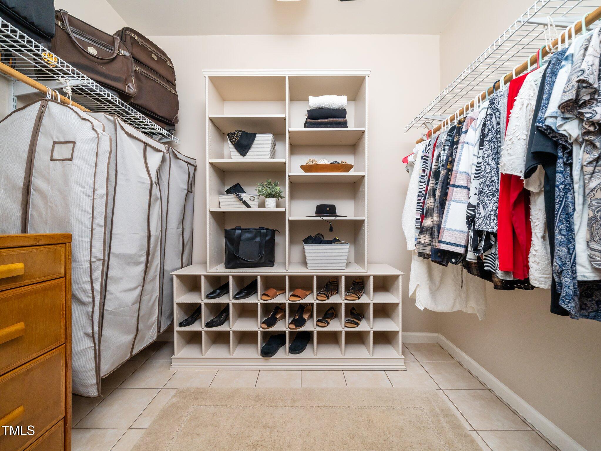 8917 Thompson Mill Road Wake Forest, NC 27587 - Photo 25 of 42 a view of walk in closet with clothes and shoes