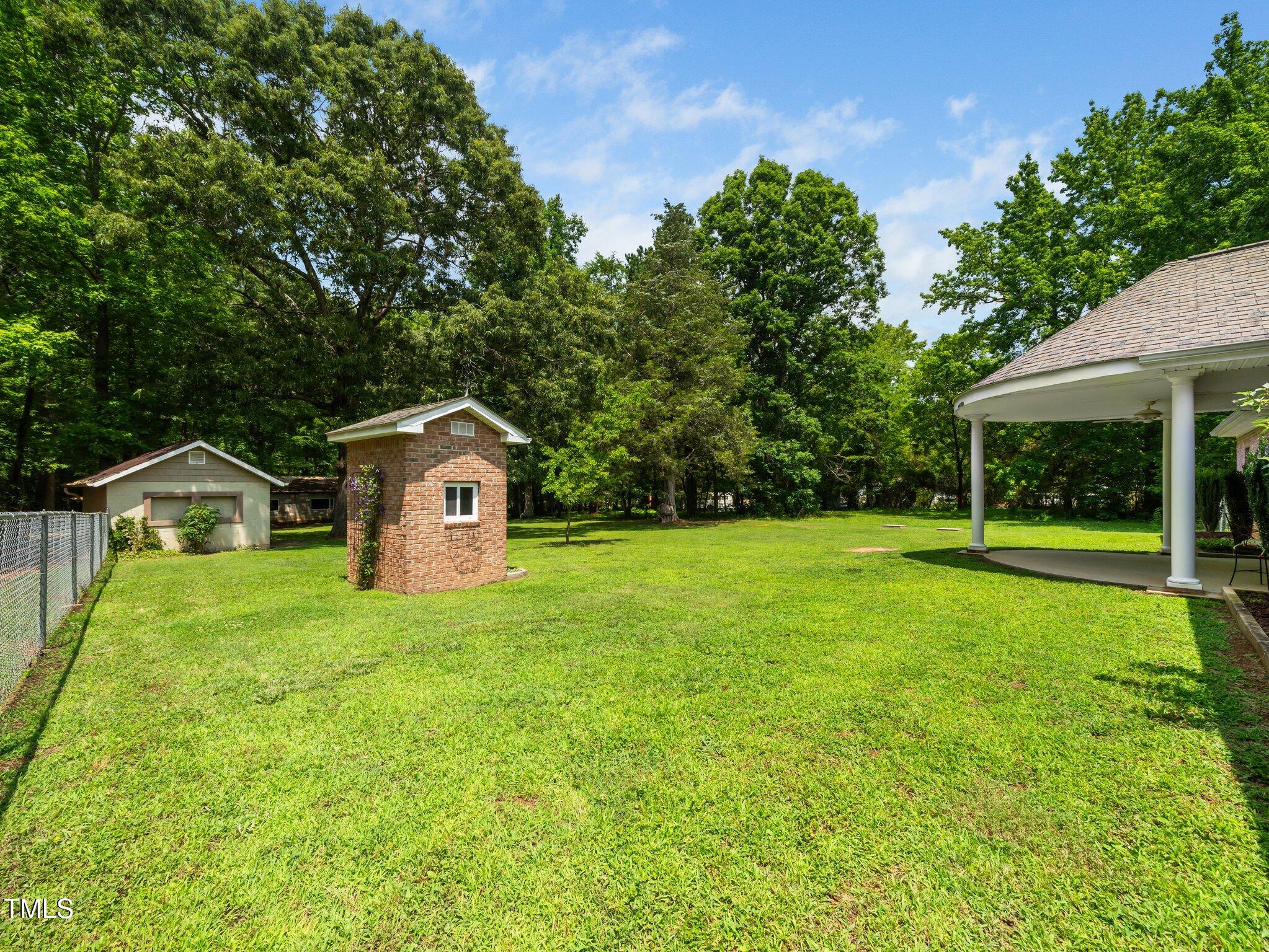 8917 Thompson Mill Road Wake Forest, NC 27587 - Photo 41 of 42 a view of a house with a yard and large trees
