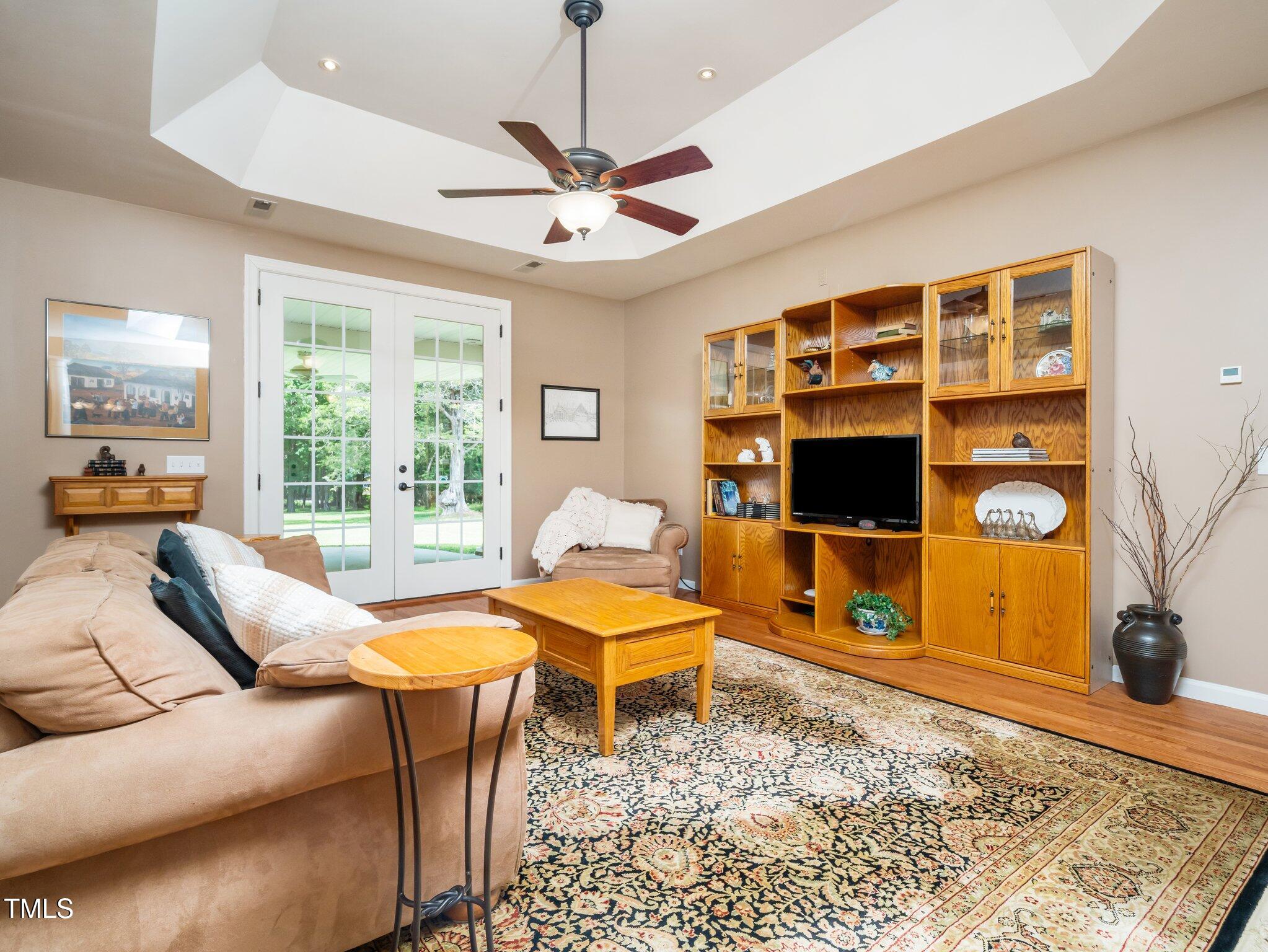 8917 Thompson Mill Road Wake Forest, NC 27587 - Photo 9 of 42 a living room with furniture a flat screen tv and a table