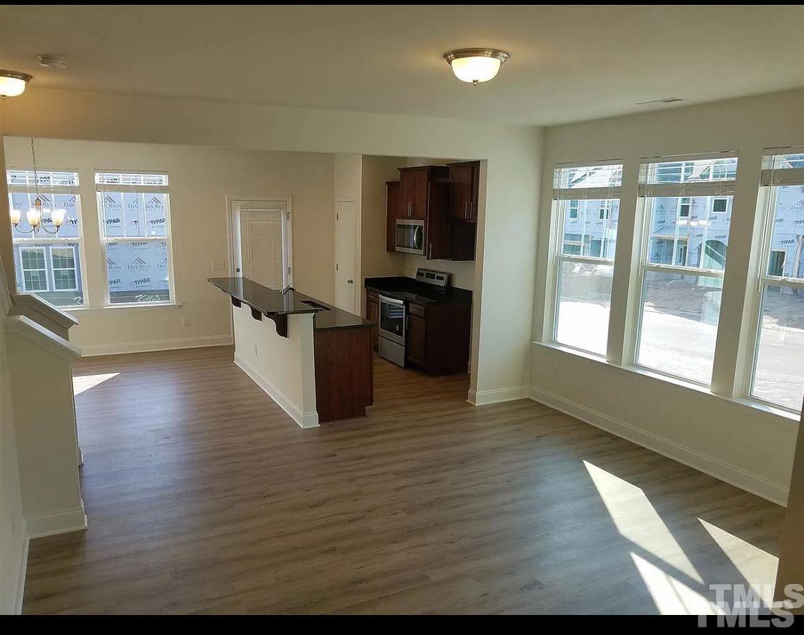 189 Wethergate Drive Clayton, NC 27527 - Photo 2 of 8 a view of a kitchen with stainless steel appliances wooden floor and a large window