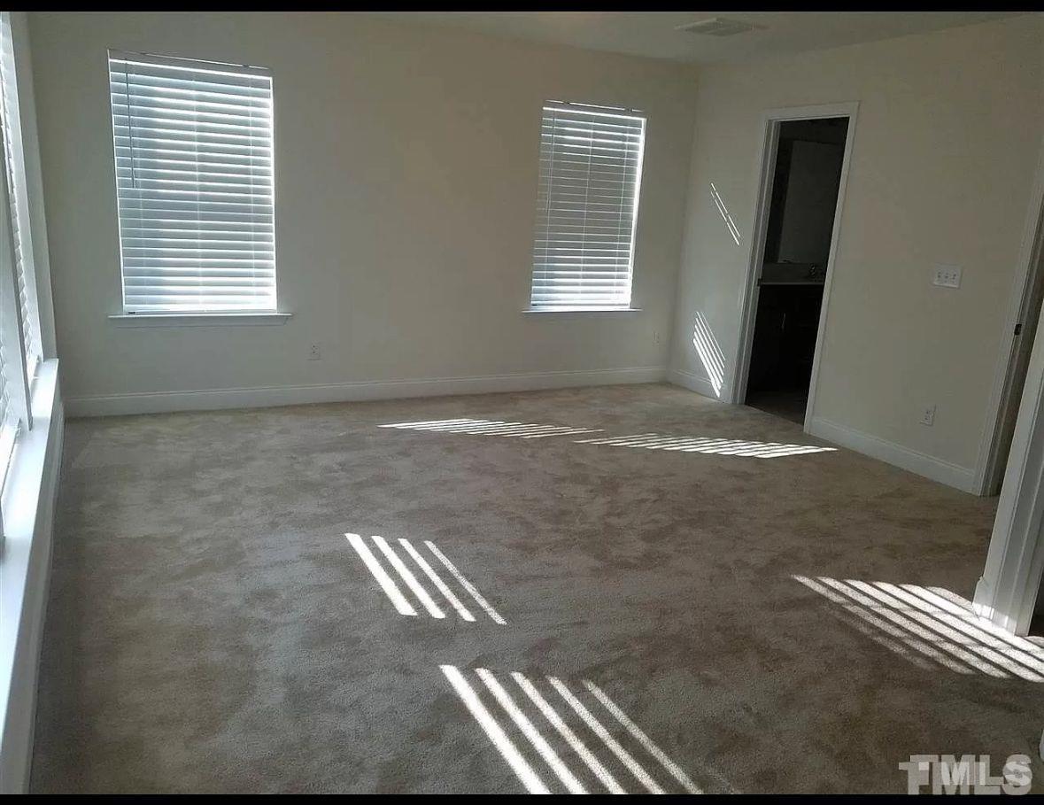 189 Wethergate Drive Clayton, NC 27527 - Photo 6 of 8 a view of an empty room and window