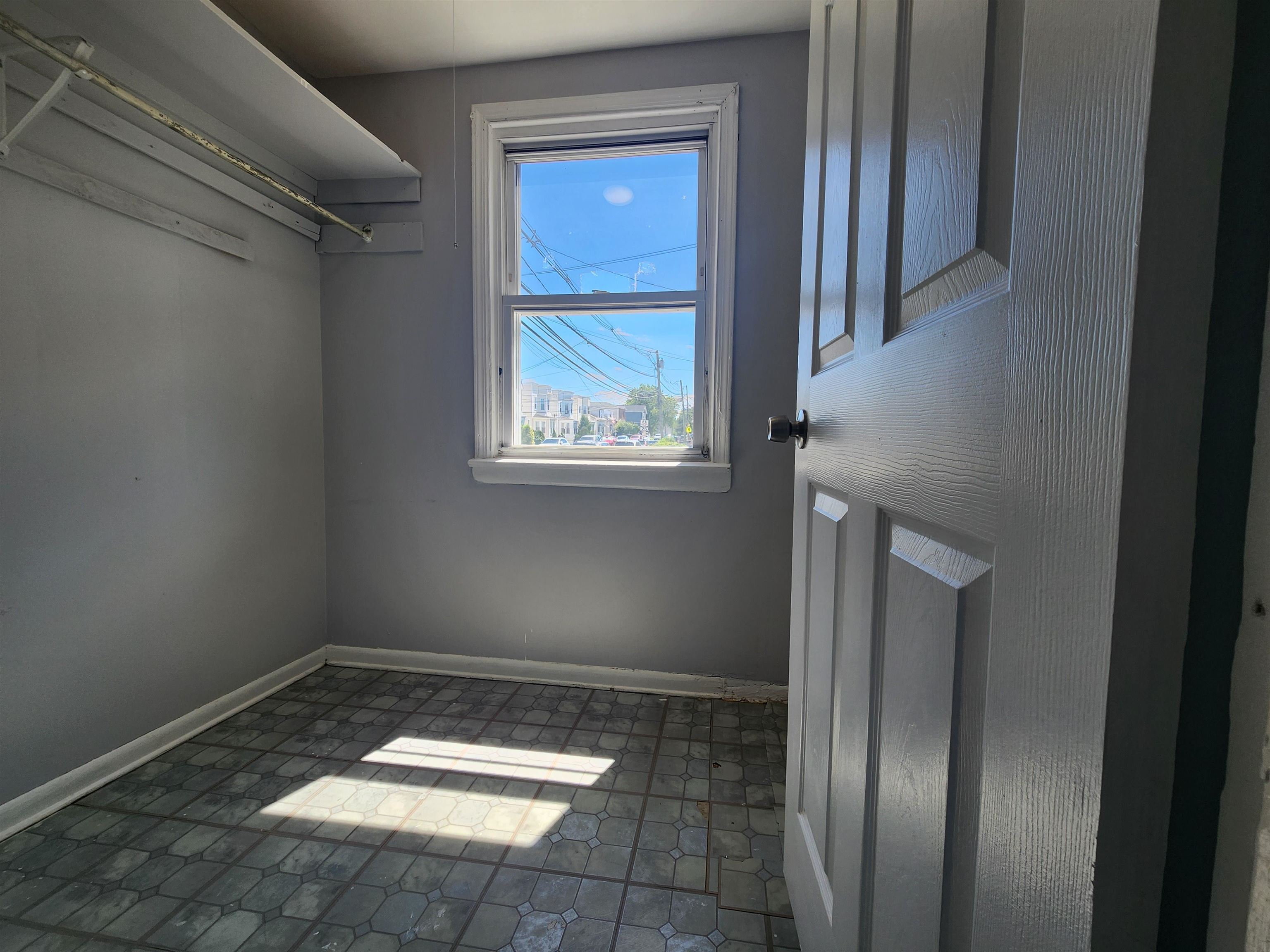 261 Centre Avenue, Unit 1 Secaucus, NJ 07094 - Photo 10 of 11 a view of an empty room with wooden floor and a window