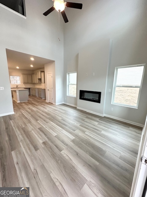 116 Deer Crossing Temple, GA 30179 - Photo 5 of 29 an empty room with wooden floor kitchen view and windows