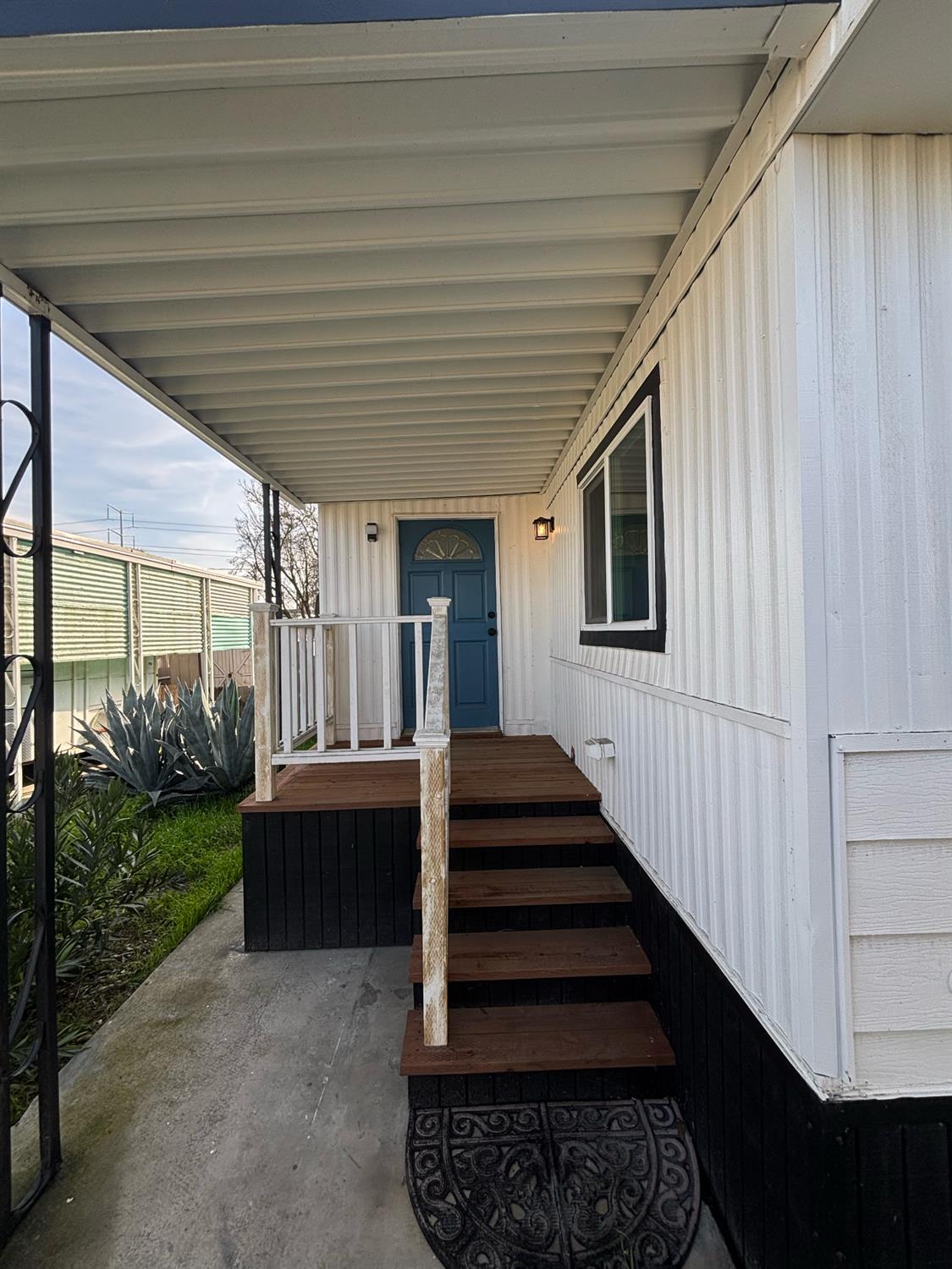 4449 South Carpenter Road, Unit B12 Modesto, CA 95358 - Photo 15 of 18 a view of a porch with wooden floors and stairs