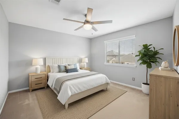 a bedroom with a large bed and a window