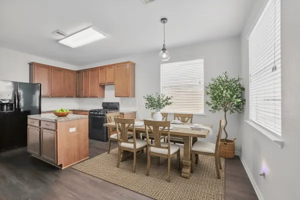 a kitchen with appliances cabinets and chair