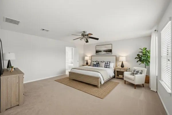 a spacious bedroom with a bed and a couch