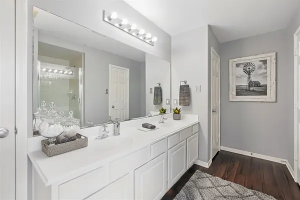 a bathroom with a sink mirror and vanity