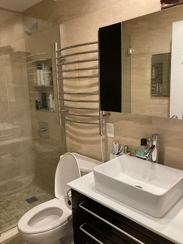 a bathroom with a sink toilet and shower