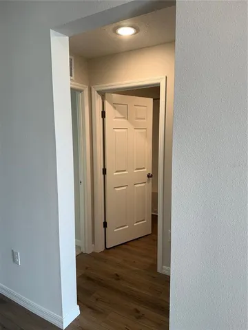 a view of a hallway with wooden floor