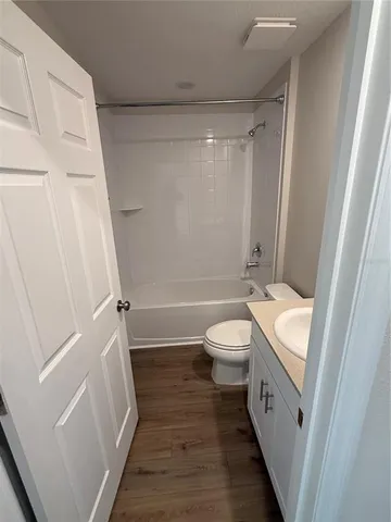 a bathroom with a sink a toilet and a shower