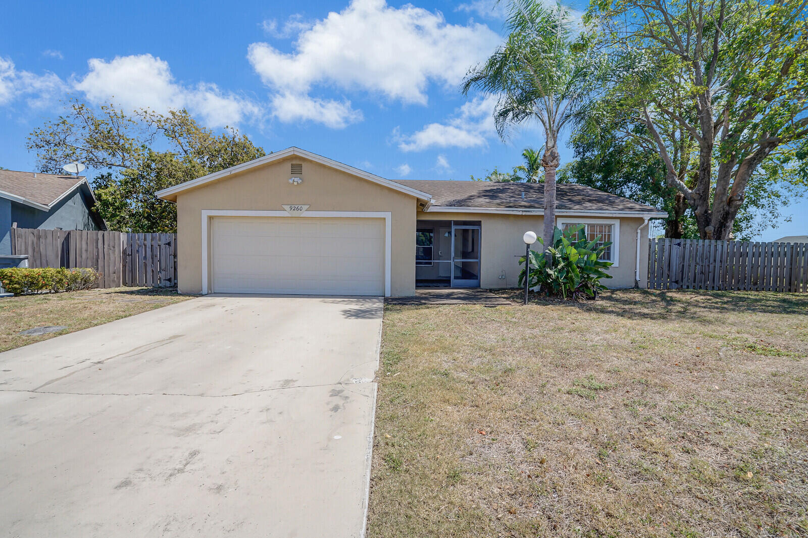 9260 Southwest 16th Road West Boca Raton, FL 33428 - Photo 1 of 46 a front view of a house with a yard and garage