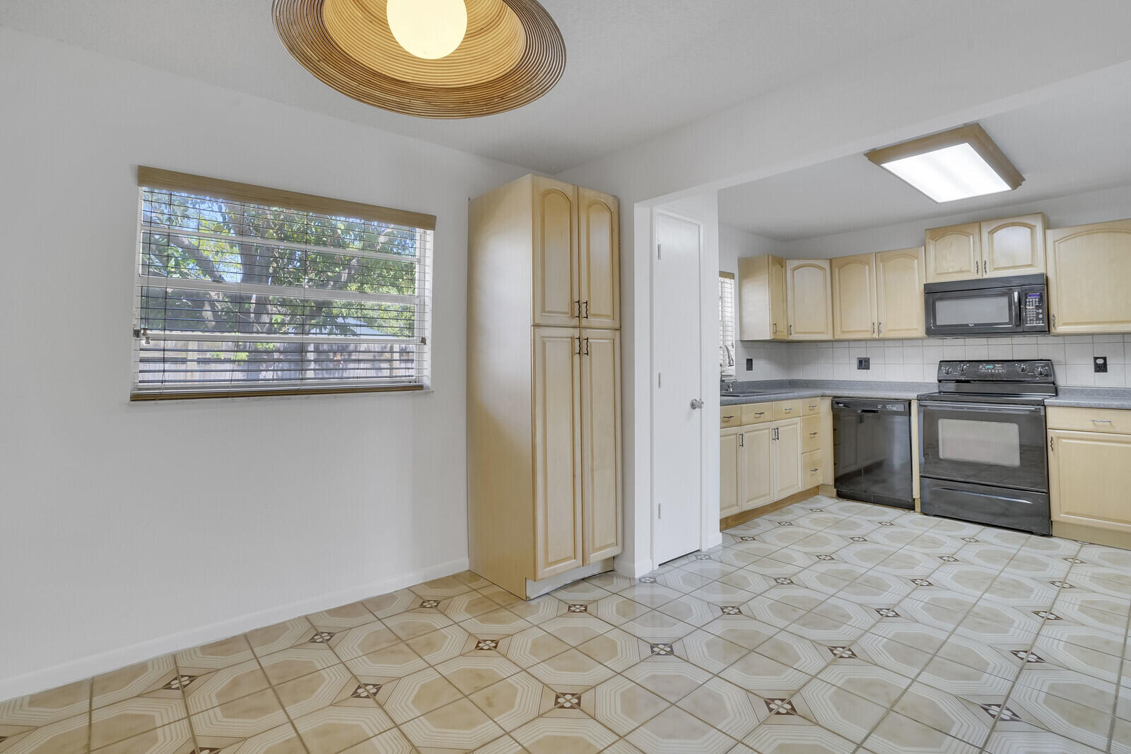 9260 Southwest 16th Road West Boca Raton, FL 33428 - Photo 12 of 46 a kitchen with stainless steel appliances granite countertop a stove a sink and a microwave
