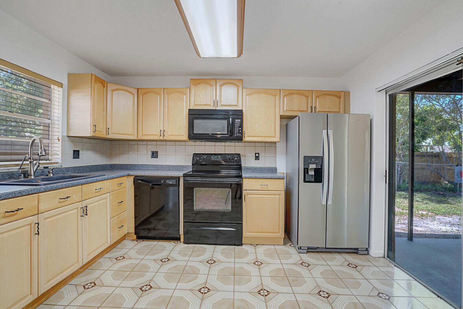9260 Southwest 16th Road West Boca Raton, FL 33428 - Photo 14 of 46 a kitchen with stainless steel appliances granite countertop a refrigerator sink and stove