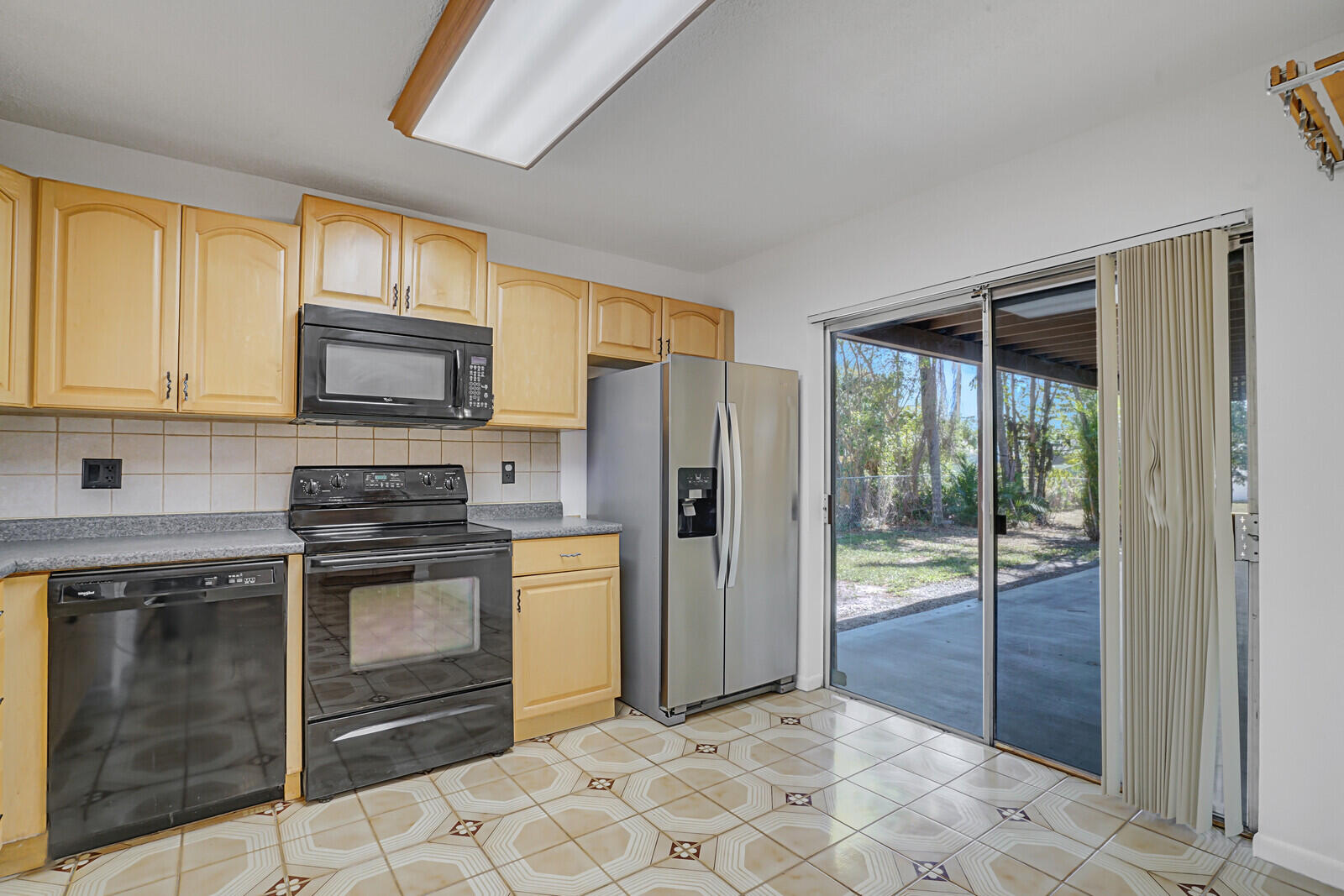 9260 Southwest 16th Road West Boca Raton, FL 33428 - Photo 15 of 46 a kitchen with stainless steel appliances granite countertop a stove a refrigerator and a sink with granite countertops