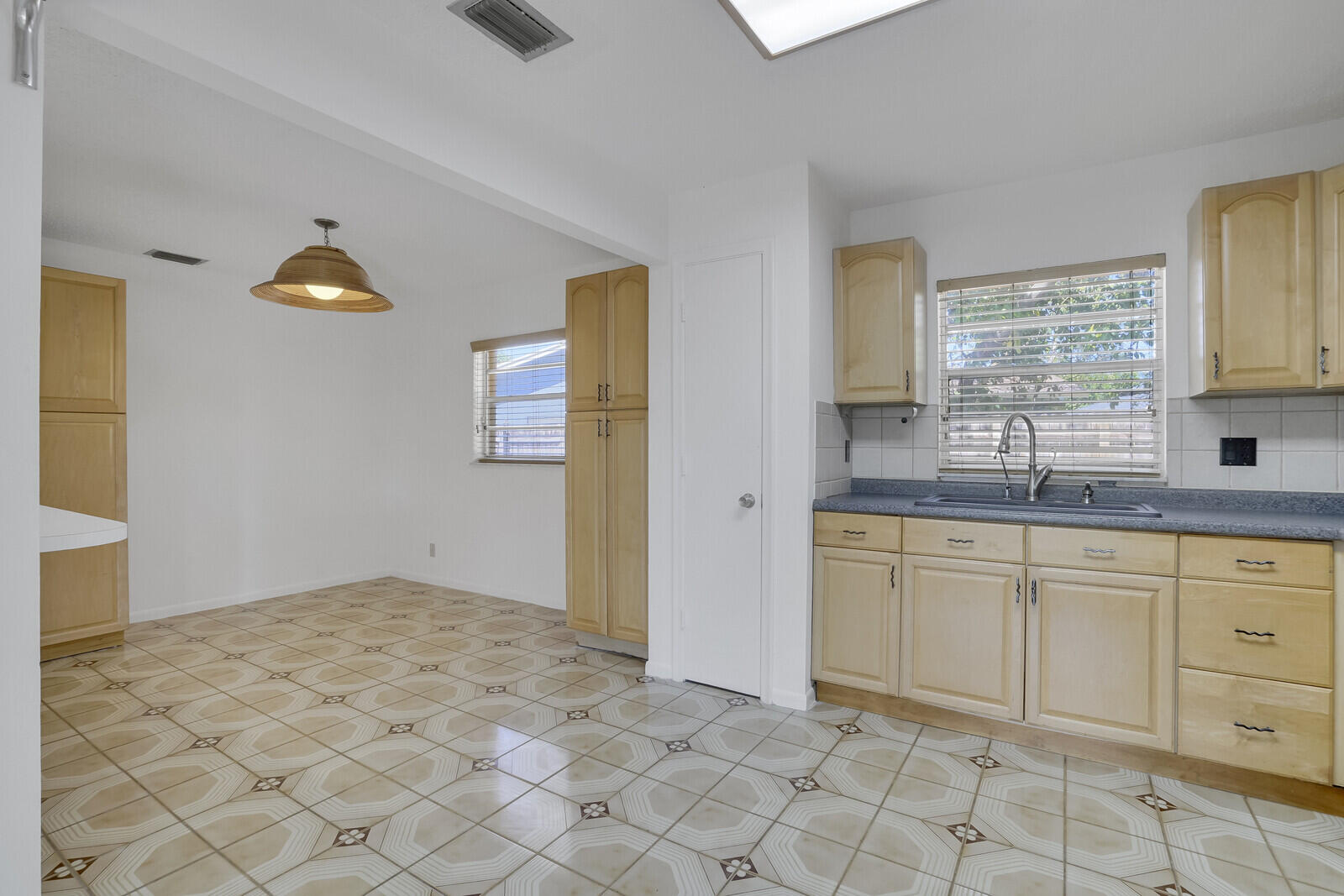 9260 Southwest 16th Road West Boca Raton, FL 33428 - Photo 17 of 46 a kitchen with granite countertop a sink white cabinets and window