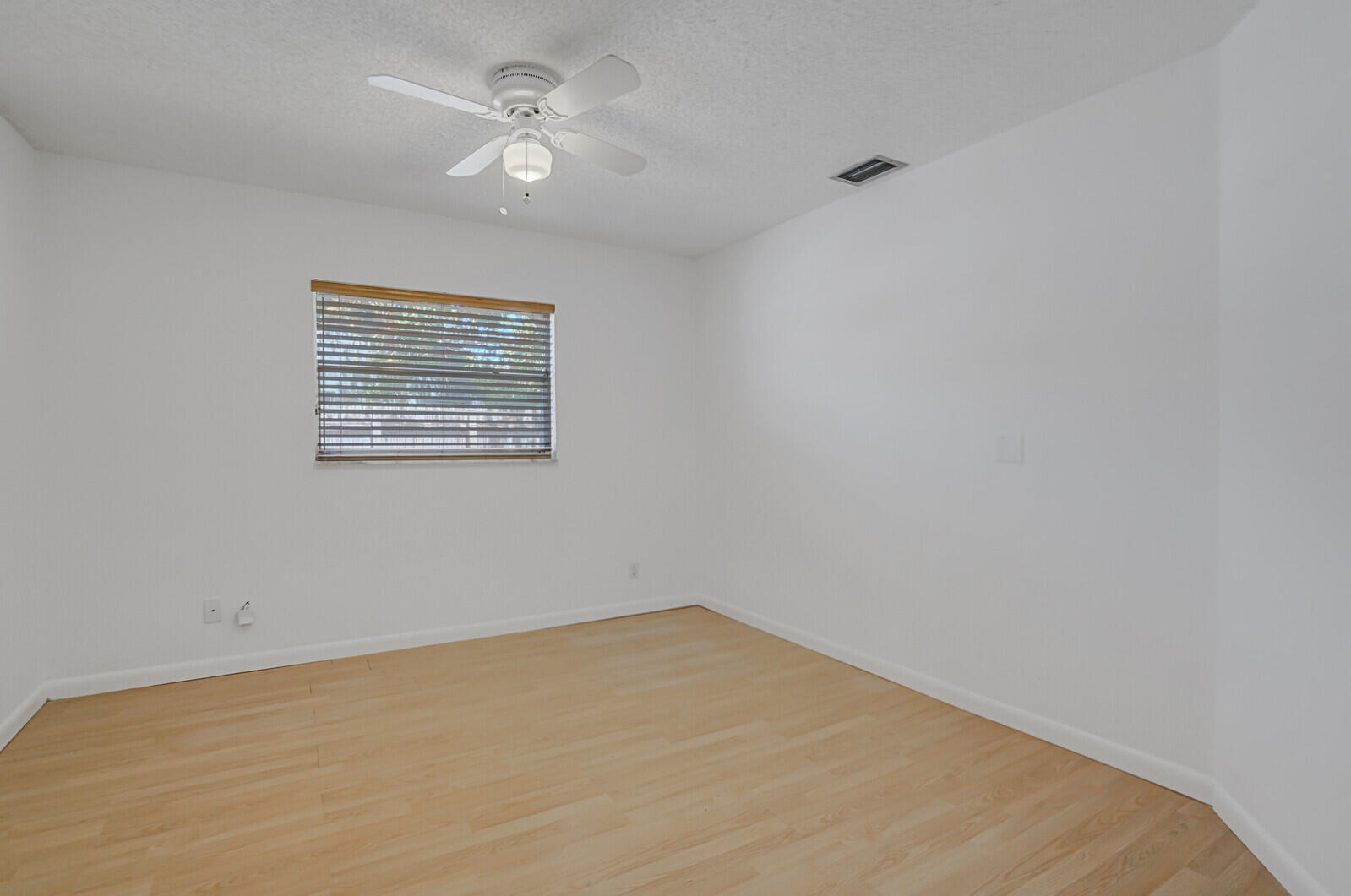 9260 Southwest 16th Road West Boca Raton, FL 33428 - Photo 18 of 46 an empty room with a window and ceiling fan