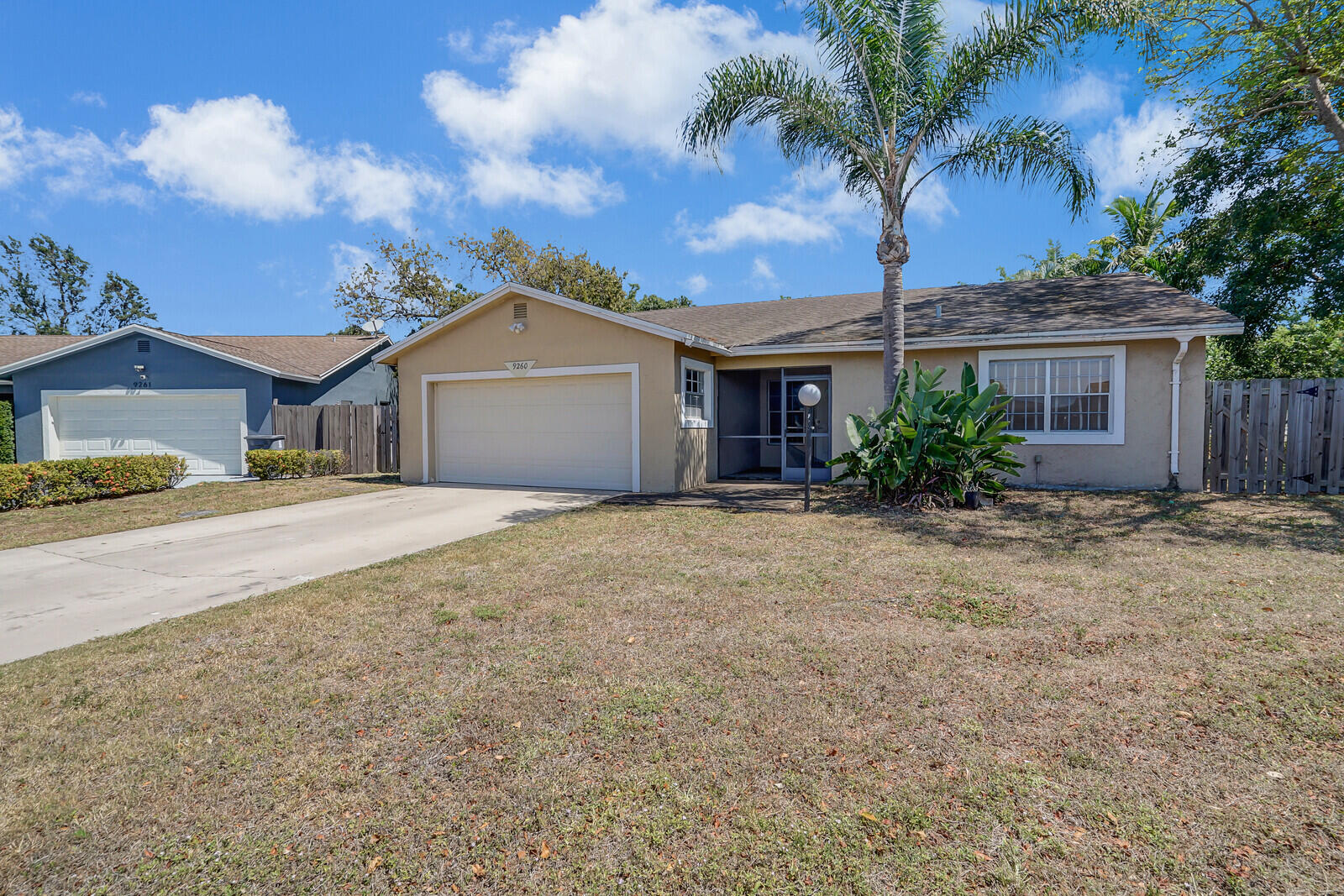 9260 Southwest 16th Road West Boca Raton, FL 33428 - Photo 2 of 46 a front view of a house with a garden