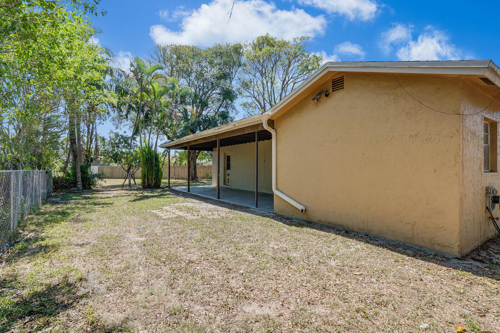 9260 Southwest 16th Road West Boca Raton, FL 33428 - Photo 32 of 46 a view of backyard with large trees and wooden fence
