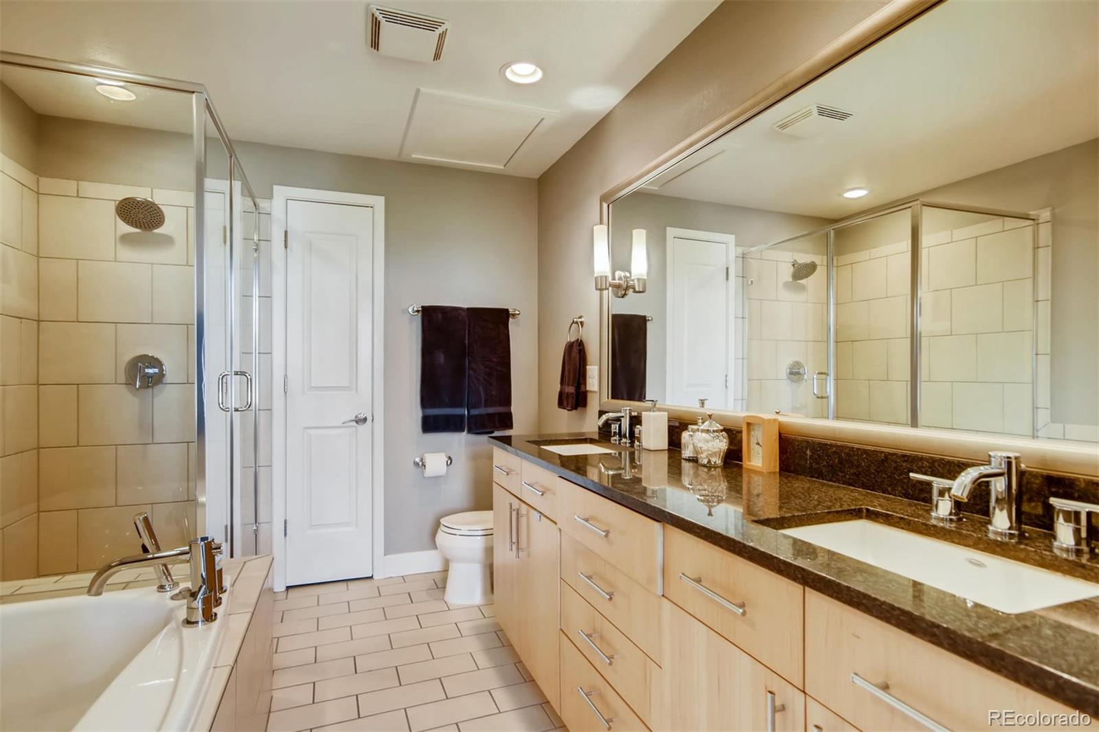 3231 Perry Street Denver, CO 80212 - Photo 17 of 36 a spacious bathroom with a double vanity sink a mirror and a shower