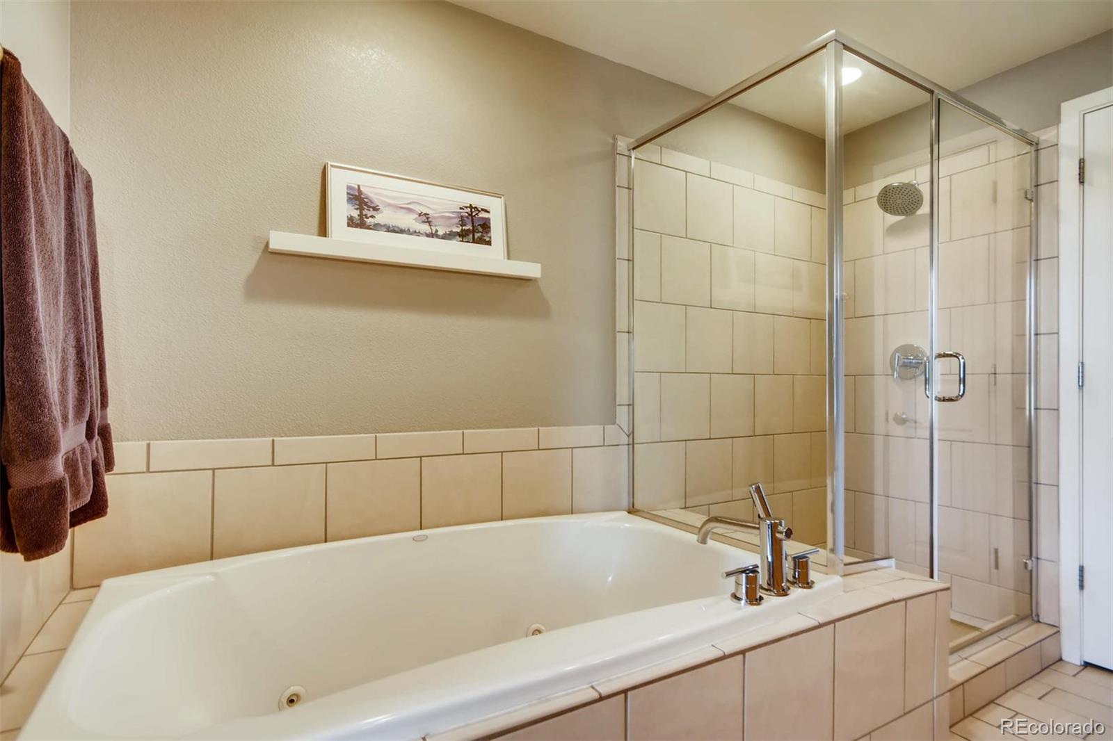 3231 Perry Street Denver, CO 80212 - Photo 18 of 36 a bathroom with a bathtub and a shower