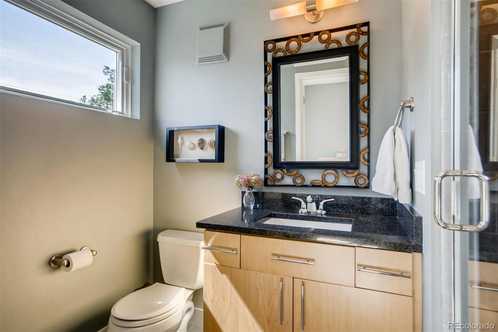 3231 Perry Street Denver, CO 80212 - Photo 20 of 36 a bathroom with a toilet sink and mirror