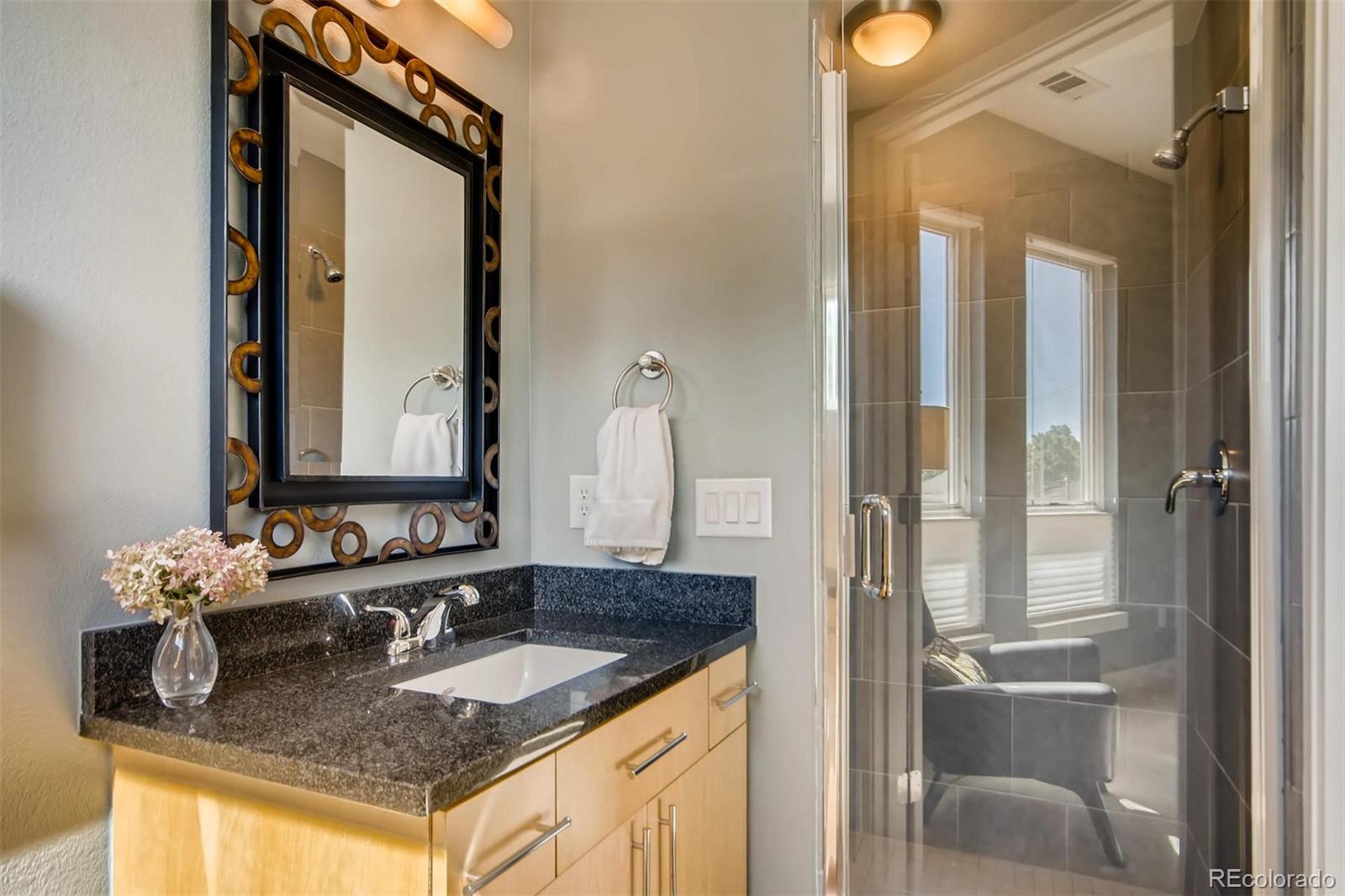 3231 Perry Street Denver, CO 80212 - Photo 21 of 36 a bathroom with a granite countertop sink and a mirror